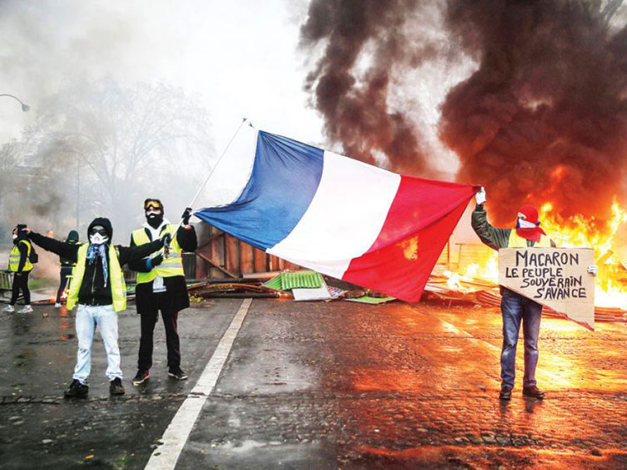 Protesters wave a french flag